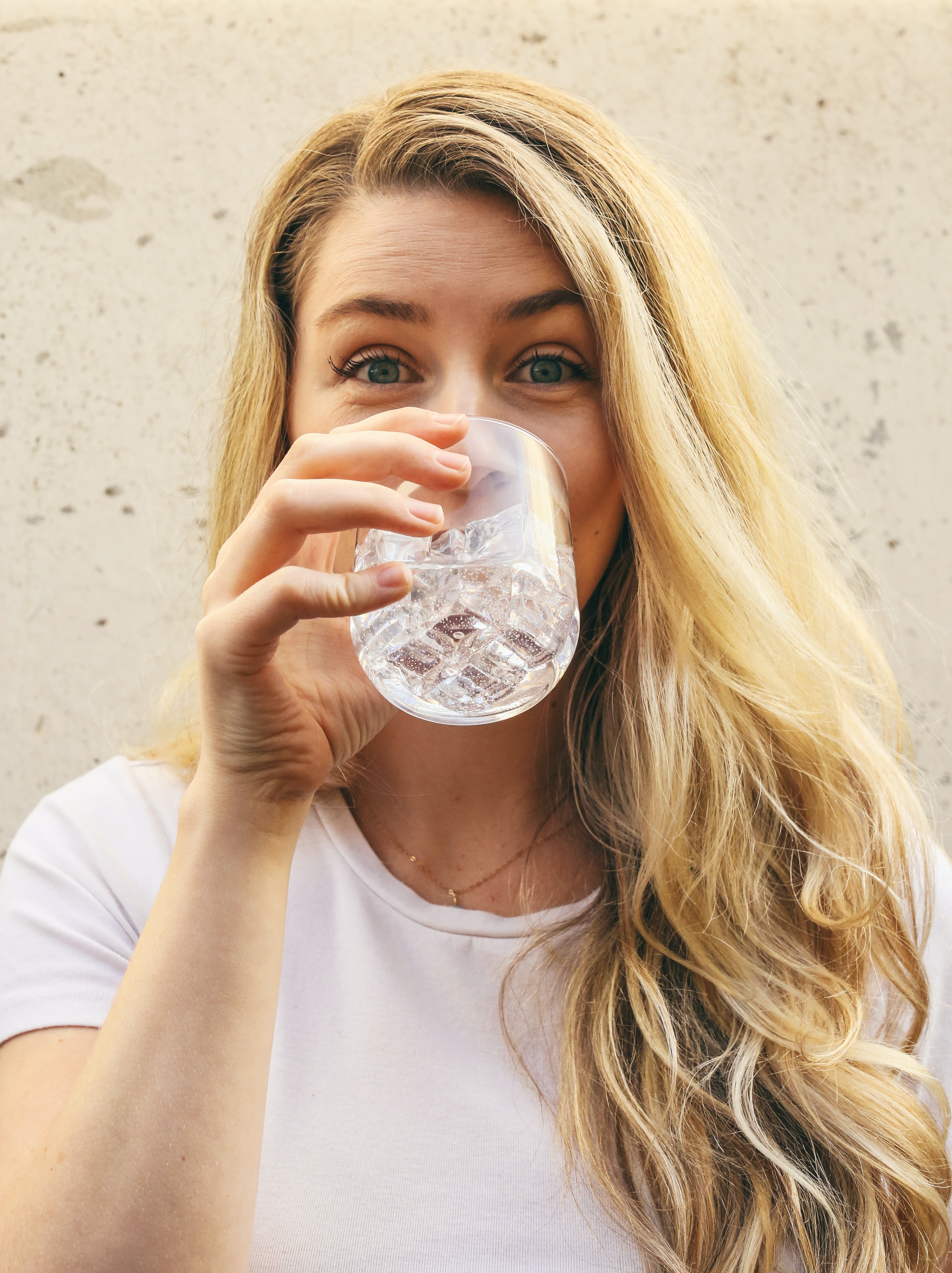 A girl smiling and having a drink